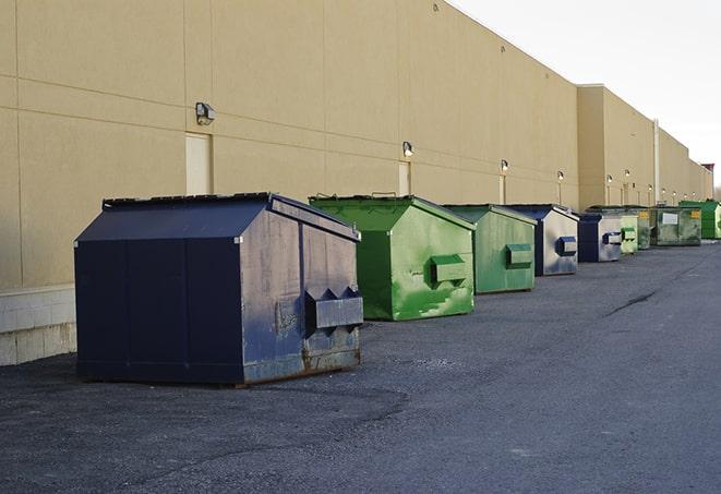 a row of industrial dumpsters for construction waste in Adah